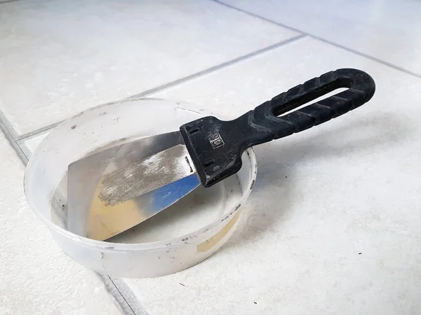 stock image Repair - metal trowel and rubber trowel for grouting