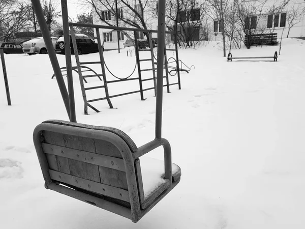 Speeltuin in de buurt van het huis in de winter - swing — Stockfoto