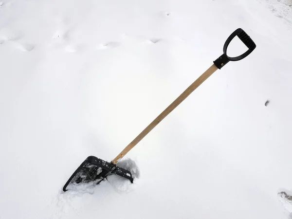 Schop sneeuw en ijs ax vast te zitten in de sneeuw in de winter — Stockfoto