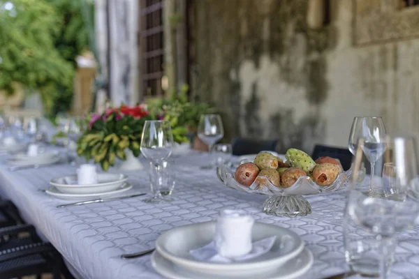 Italy, Sicily, Set table in the garden of a farm house in the countryside