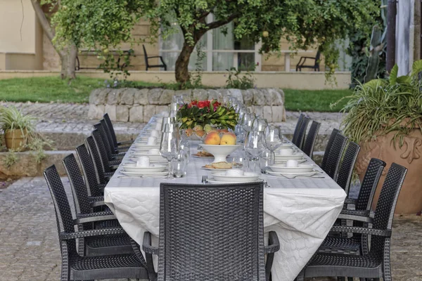 Italy, Sicily, Set table in the garden of a farm house in the countryside