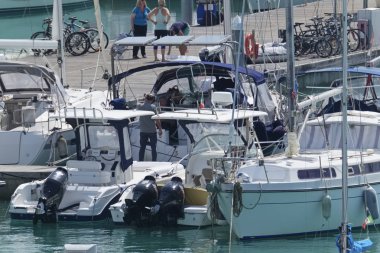 İtalya, Sicilya, Akdeniz, Marina di Ragusa; 6 Nisan 2019, insanlar, motorlu tekneler ve limanda Lüks Yatlar-editoryal