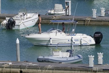 İtalya, Sicilya, Akdeniz, Marina di Ragusa (Ragusa eyaleti); 8 Haziran 2019, liman içinde bir motorlu tekne insanlar-editoryal