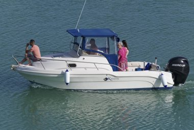 İtalya, Sicilya, Akdeniz, Marina di Ragusa (Ragusa eyaleti); 9 Haziran 2019, limanda bir motorlu teknede insanlar-editoryal