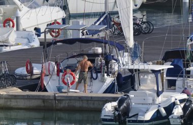 İtalya, Sicilya, Akdeniz, Marina di Ragusa (Ragusa Eyaleti); 15 Ekim 2019, limandaki insanlar, motorlu tekneler ve lüks yatlar -