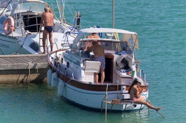 İtalya, Sicilya, Akdeniz, Marina di Ragusa (Ragusa Eyaleti); 2 Temmuz 2020, limanda lüks bir yatta insanlar - EDITORIAL