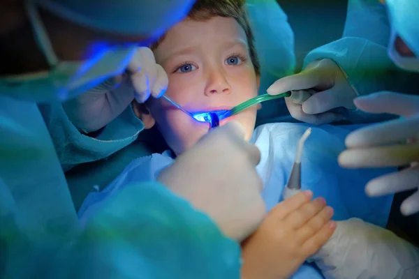 4 years old male child being cured in a dentist clinic