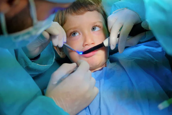 4 years old male child being cured in a dentist clinic