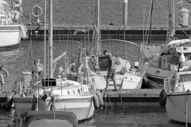 İtalya, Sicilya, Akdeniz, Marina di Ragusa (Ragusa Eyaleti); 9 Temmuz 2020, limandaki insanlar ve lüks yatlar - EDITORIAL