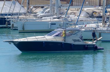 İtalya, Sicilya, Akdeniz, Marina di Ragusa (Ragusa Eyaleti); 12 Temmuz 2020, limanda lüks bir yatta insanlar - EDITORIAL