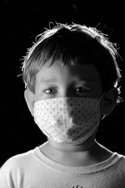 Studio portrait of a 4 years old male child wearing a protective mask