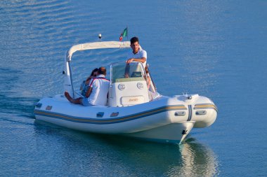 İtalya, Sicilya, Akdeniz, Marina di Ragusa (Ragusa Eyaleti); 25 Temmuz 2020, limandaki kauçuk bir teknede insanlar - EDITORIAL