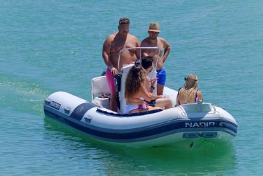 İtalya, Sicilya, Akdeniz, Marina di Ragusa (Ragusa Eyaleti); 26 Temmuz 2020, limandaki kauçuk bir teknede insanlar - EDITORIAL