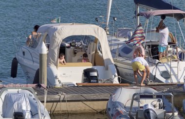 İtalya, Sicilya, Akdeniz, Marina di Ragusa (Ragusa Eyaleti); 7 Ağustos 2020, limandaki lüks yatlarda yaşayan insanlar - EDITORIAL