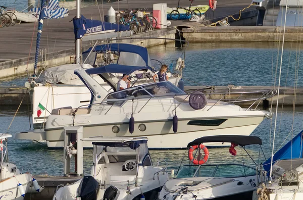 İtalya, Sicilya, Akdeniz, Marina di Ragusa (Ragusa Eyaleti); 2 Eylül 2020, limanda lüks bir yatta çift - EDITORIAL