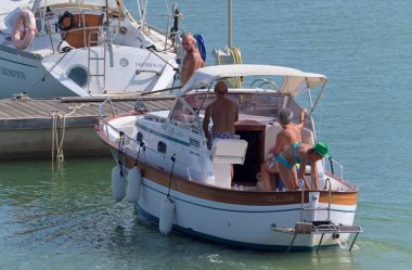 İtalya, Sicilya, Akdeniz, Marina di Ragusa (Ragusa Eyaleti); 6 Eylül 2020, limanda lüks bir yatta insanlar - EDITORIAL