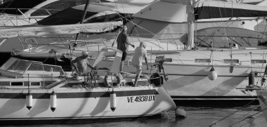 Italy, Sicily, Mediterranean Sea, Marina di Ragusa (Ragusa Province); 4 September 2025, people on a sailing boat and luxury yachts in the port - EDITORIAL