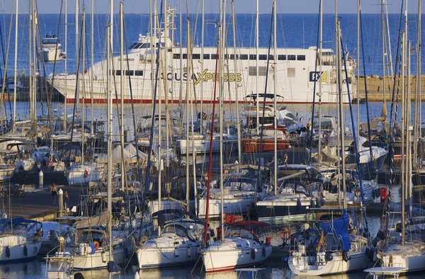 Italy, Sicily, Mediterranean sea, Marina di Ragusa (Ragusa Province); 5 September 2025, the ferry that connects Sicily with Malta island and luxury yachts in the port - EDITORIAL