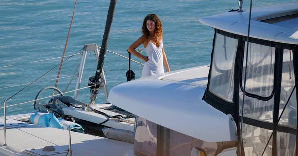 Italy, Sicily, Mediterranean Sea, Marina di Ragusa (Ragusa Province); 7 September 2025, woman on a catamaran sailing boat in the port - EDITORIAL