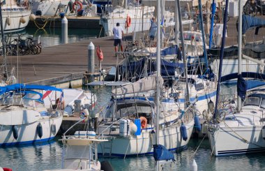 Italy, Sicily, Mediterranean sea, Marina di Ragusa (Ragusa Province); people and luxury yachts in the port 