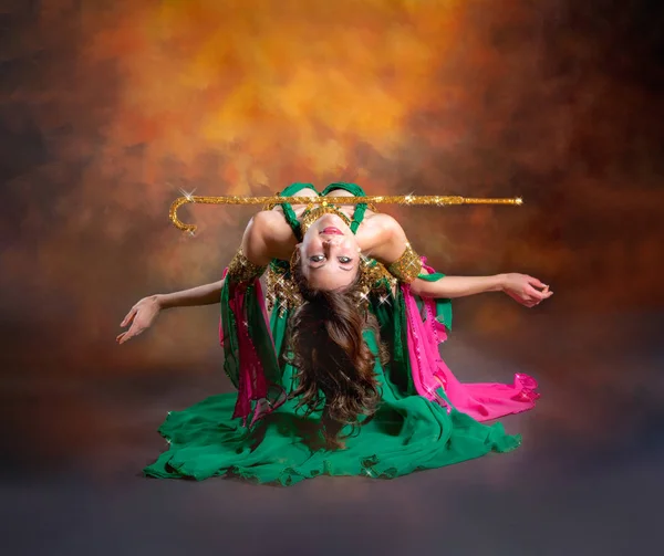 Gorgeous woman bellydancer dancing in traditional bellydance costume over colored studio background. — Stock Photo, Image