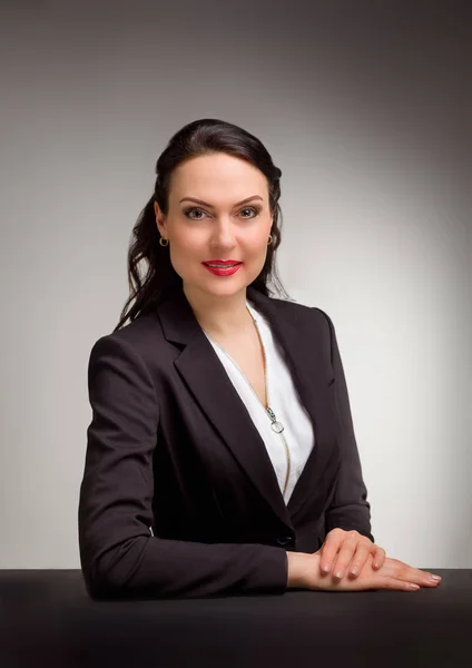 Portrait of wonderful business woman on gray background — Stok Foto