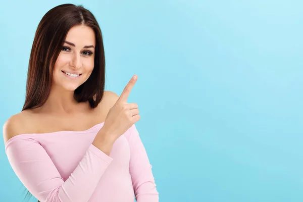 Woman against blue wall background — Stock Photo, Image