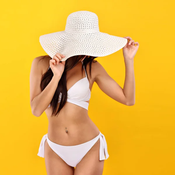 Sexy vrouw in bikini poseren tegen gele achtergrond — Stockfoto