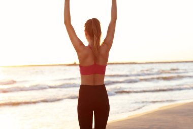 Güzel gün batımında sahilde tek başına çalışan kadın