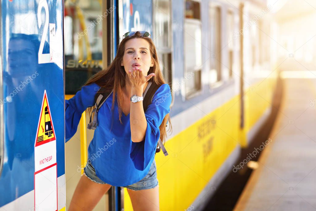 Young woman tourist at platform train station