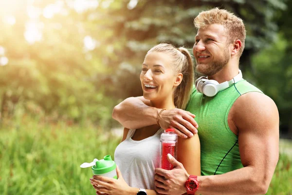 Genç çift parkta koşuyor.