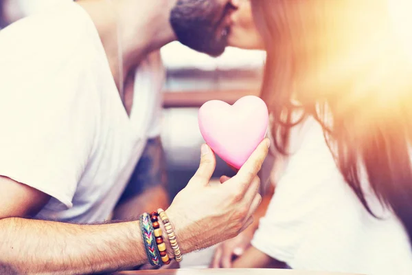 Romantic couple dating in cafe and holding presents — Stock Photo, Image