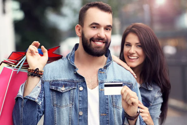 Retrato de pareja feliz con bolsas de compras después de comprar en la ciudad — Foto de Stock