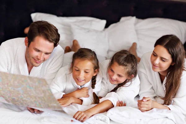 Happy family relaxing in hotel room — Stock Photo, Image