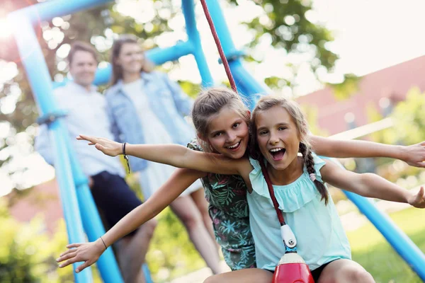 Glada familjen ha roligt på lekplatsen — Stockfoto