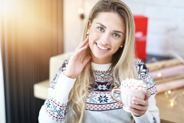 Adult woman relaxing at home during Christmas time