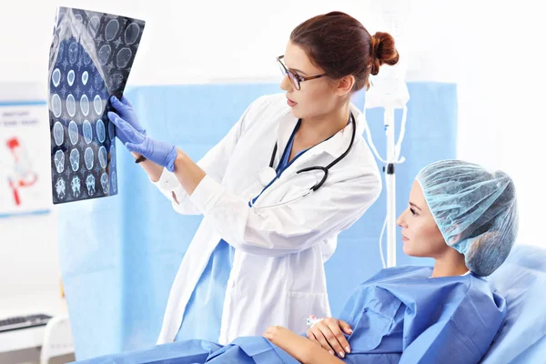 Female doctor taking care of patient in hospital — Stock Photo, Image