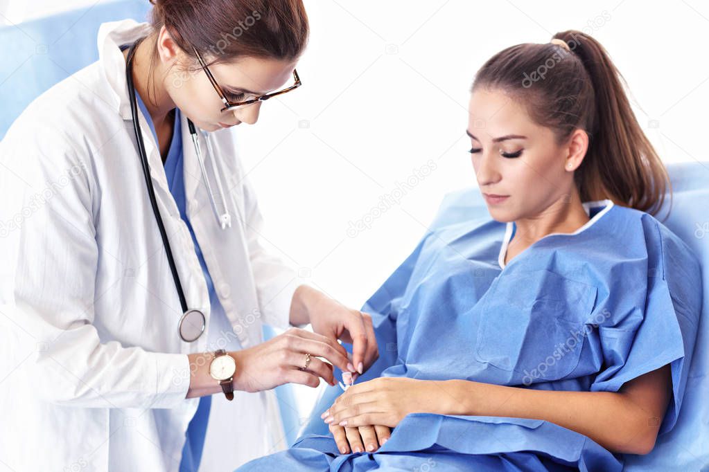 Female doctor taking care of patient in hospital