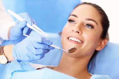 Adult woman having a visit at the dentists clipart