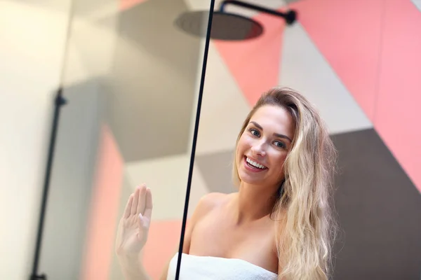 Красивая белокурая белая женщина позирует в ванной комнате с мокрыми волосами — стоковое фото