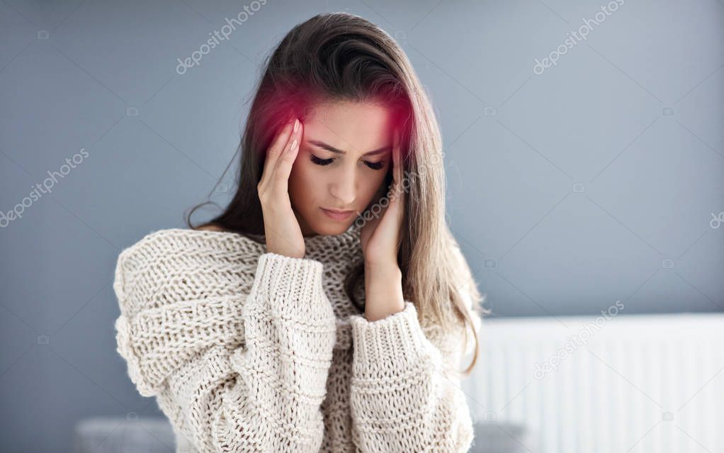 Picture of adult woman suffering from headache at home