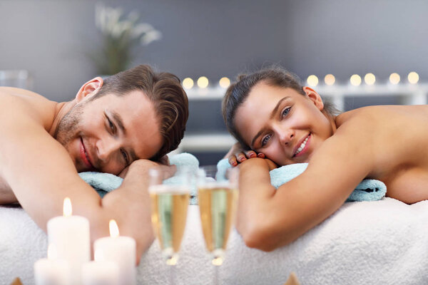 Adult happy couple relaxing in spa salon
