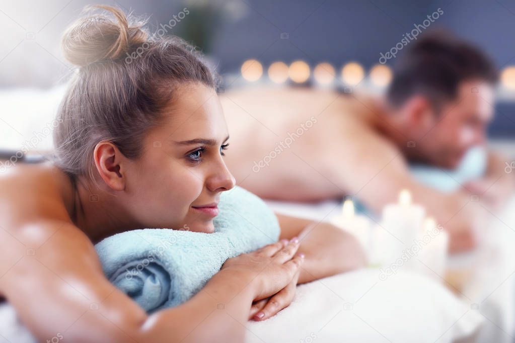 Adult happy couple relaxing in spa salon