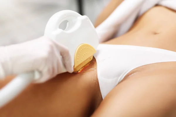 Kosmetolog ge epilation laser behandling till kvinna på bikini — Stockfoto