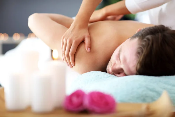 Hombre guapo teniendo masaje en el salón de spa —  Fotos de Stock