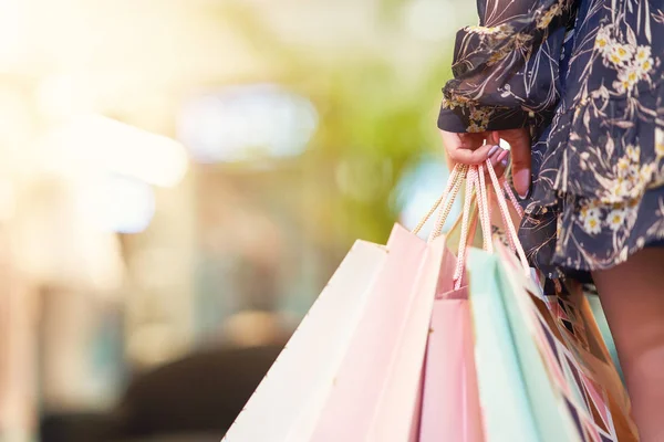 Happy woman shopping for clothes in store