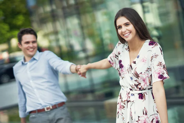 Retrato de casal feliz com sacos de compras na cidade sorrindo e abraçando . — Fotografia de Stock