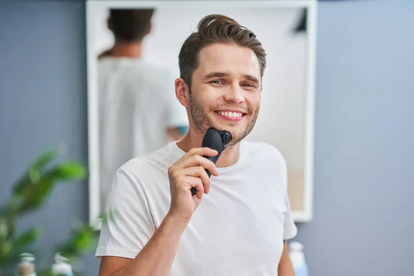 Portrait of adult man shaving in the bathroom — Stock Photo, Image