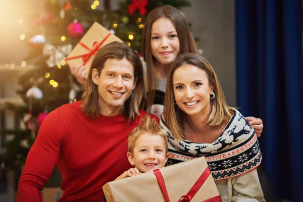 Bella famiglia con regali sopra l'albero di Natale — Foto Stock