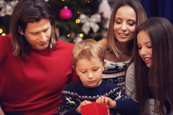 Hermosa familia con regalos sobre el árbol de Navidad — Foto de Stock